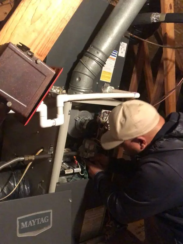 Four Seasons technician on a Maytag attic furnace